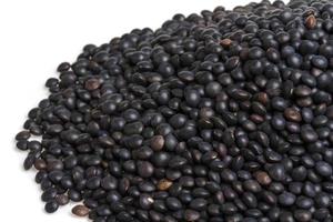 Heap of black lentil isolated on white photo