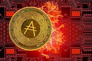 burning golden valueable single cardano coin from crypto currency with a red board in the back photo
