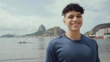 Latin young man, famous beach Rio de Janeiro, Brazil. Latin summer vacation holiday. photo