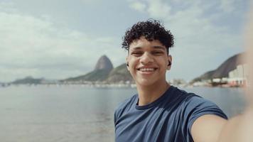 Latin young man, famous beach Rio de Janeiro, Brazil. Latin summer vacation holiday. photo