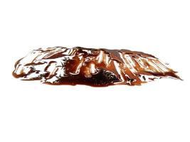 Texture of spilled soy sauce. Soy sauce on white background. Spilled soy sauce sauce puddle isolated on white background photo