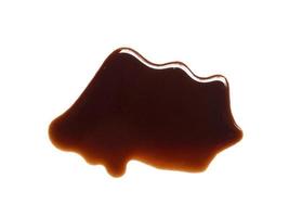 Texture of spilled soy sauce. Soy sauce on white background. Spilled soy sauce sauce puddle isolated on white background photo