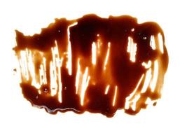 Soy sauce on white background. Spilled soy sauce sauce puddle isolated on white background. Texture of spilled soy sauce photo