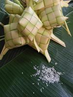 Ketupat, a type of dumpling made from rice packed inside a diamond-shaped container of woven palm leaf pouch. commonly found in Indonesia, Malaysia, Brunei, Singapore, and the Philippines. photo