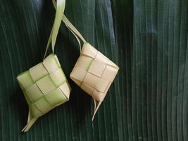 Ketupat, a type of dumpling made from rice packed inside a diamond-shaped container of woven palm leaf pouch. commonly found in Indonesia, Malaysia, Brunei, Singapore, and the Philippines. photo