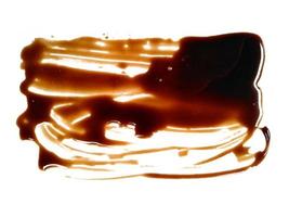 Spilled soy sauce sauce puddle isolated on white background. Texture of spilled soy sauce. Soy sauce on white background photo