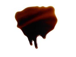 Spilled soy sauce sauce puddle isolated on white background. Texture of spilled soy sauce. Soy sauce on white background photo