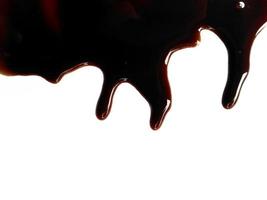 Soy sauce on white background. Spilled soy sauce sauce puddle isolated on white background. Texture of spilled soy sauce photo