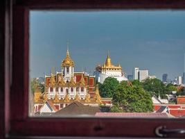 Bangkok, Thailand, 2022 - The Brazen Palace or Loha Prasat at Ratchanaddaram Temple and the Golden Mountain of Wat Saket Ratchaworawihan. photo