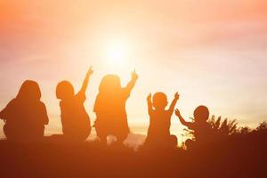 silhouette of a happy children and happy time sunset photo
