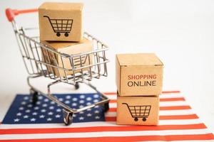 Box with shopping online cart logo and USA America flag, Import Export Shopping online or commerce finance delivery service store product shipping, trade, supplier concept. photo