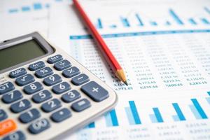 Calculator on chart and graph spreadsheet paper. Finance development, Banking Account, Statistics, Investment Analytic research data economy, Stock exchange trading, Business company concept. photo