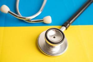 Black stethoscope on Ukraine flag background, Business and finance concept. photo