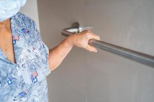 Asian senior or elderly old lady woman patient use toilet bathroom handle security in nursing hospital ward, healthy strong medical concept. photo