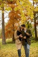 Young couple walking in the autumn park photo