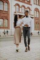 Young multiethnic couple walking on the street photo