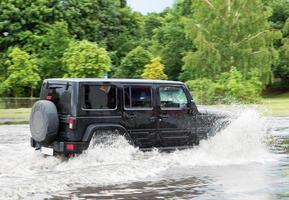 Gdansk, Poland, 2022 -Car trying to drive against flood on the street in Gdansk, Poland. photo