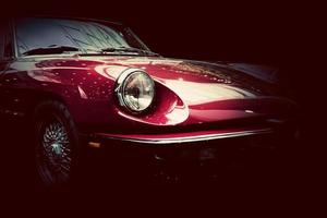 Retro classic car on dark background. Vintage, elegant photo