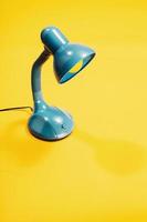 Blue lamp on a yellow background. photo