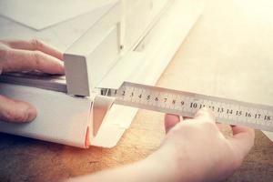 Man does measuring with slide calliper in paper cutter photo