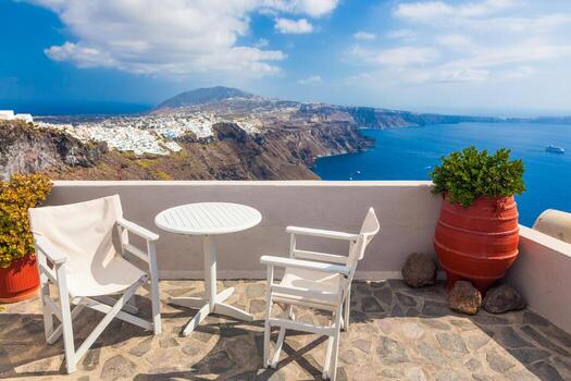 mesa y sillas en el techo con vistas panorámicas a la isla de santorini, grecia. foto