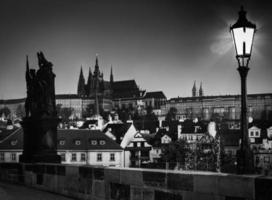 Charles Bridge at sunrise, Prague, Czech Republic. View on Prague Castle with St. Vitus Cathedral. photo