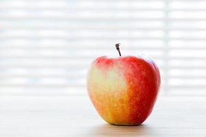 Ripe apple on the table in morning light. Diet breakfast, healthy food photo