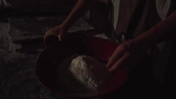 Slow Motion Pan of Adult Hand Mixing Dry Dough Ingredients in a Large Bowl