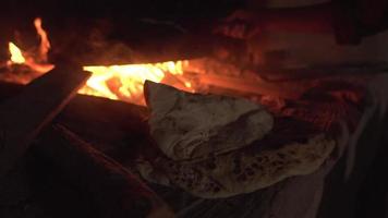 Bread Dough Tossed on Stone in Oven Over Fire to Bake video