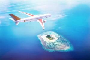 Airplane flying over Maldives islands on Indian Ocean. Travel photo