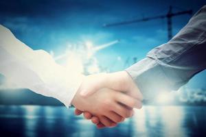 Business handshake in shipyard. Industry, deal, contract. photo