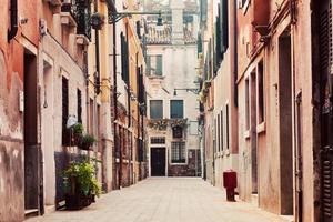 A narrow, old street in Venice, Italy photo