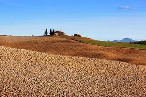 Tuscany landscape. Field, farm house among cypress trees. Italy photo