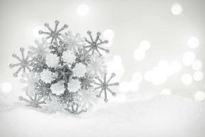 Winter snowflake decoration on glitter background. photo