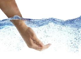 Woman's hand taking the water. photo