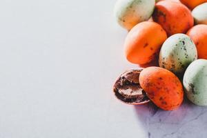 Colorful chocolate eggs on light background photo