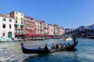 Venice, Italy, 2022 - Gondola with tourists floats on Grand Canal photo