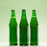 Three green bottles on a light green background. photo