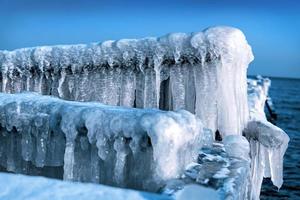 Frozen jetty on the sea. Ice, winter photo