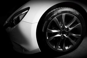 Luxury sports car close up of aluminium rim and headlight photo