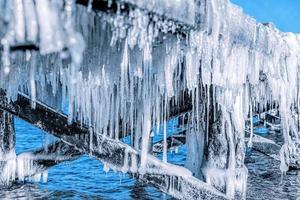 Icicle hanging under jetty roof. Ice, winter. photo