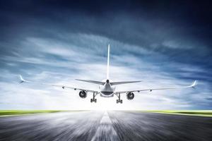 Passenger airplane taking off on runway photo