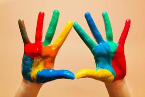 Painted hands, colorful fun. Orange background photo