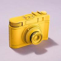 Yellow camera on pastel background. photo