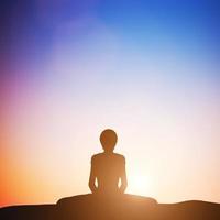 3D Woman in bound angle yoga pose meditating at sunset. Zen photo