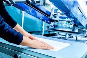 Worker setting print screening metal machine photo