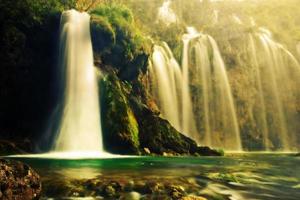 Waterfall in forest. Crystal clear water. photo