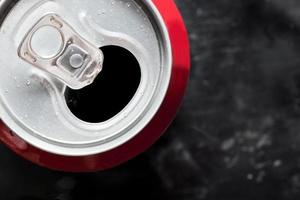 Soda can top close up with water drops photo