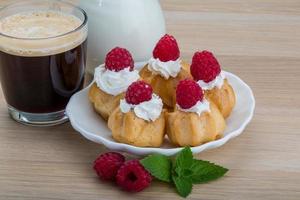 Profiterole with raspberry photo