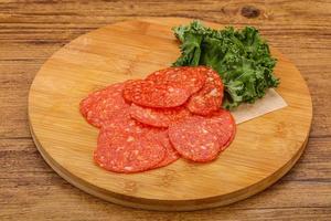 Italian spycy pepperoni sausage slices photo